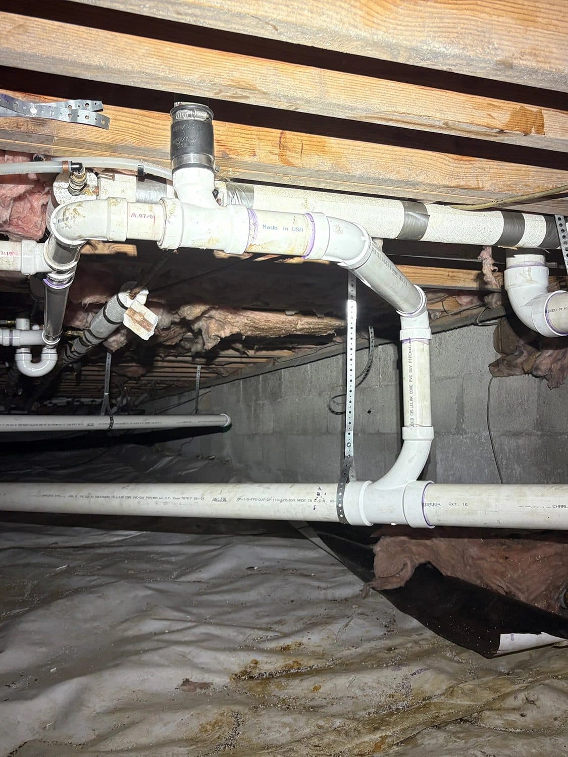 New PVC drain piping installed in a crawl space under a Middle Tennessee home