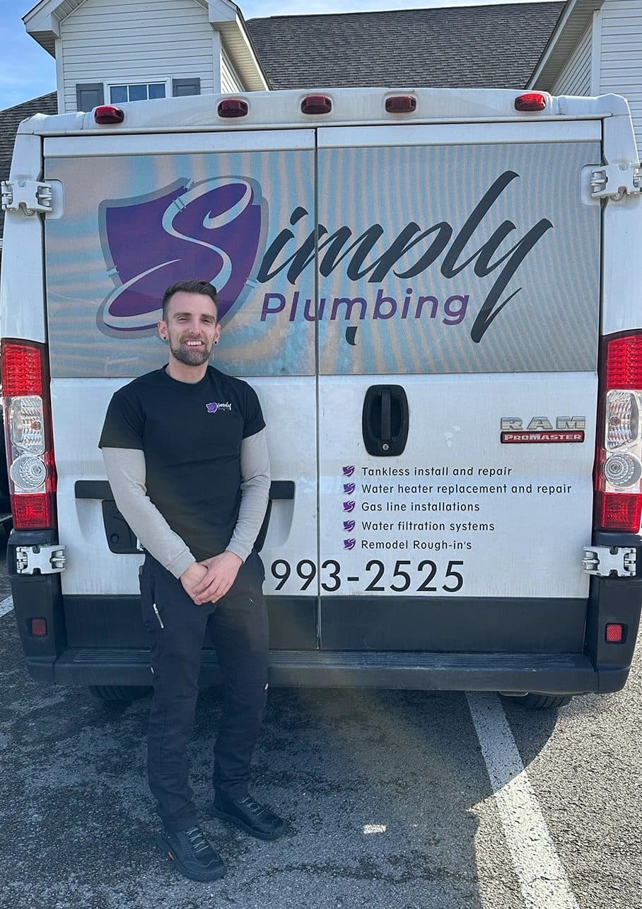 Simply Plumbing plumber standing in front of the company van