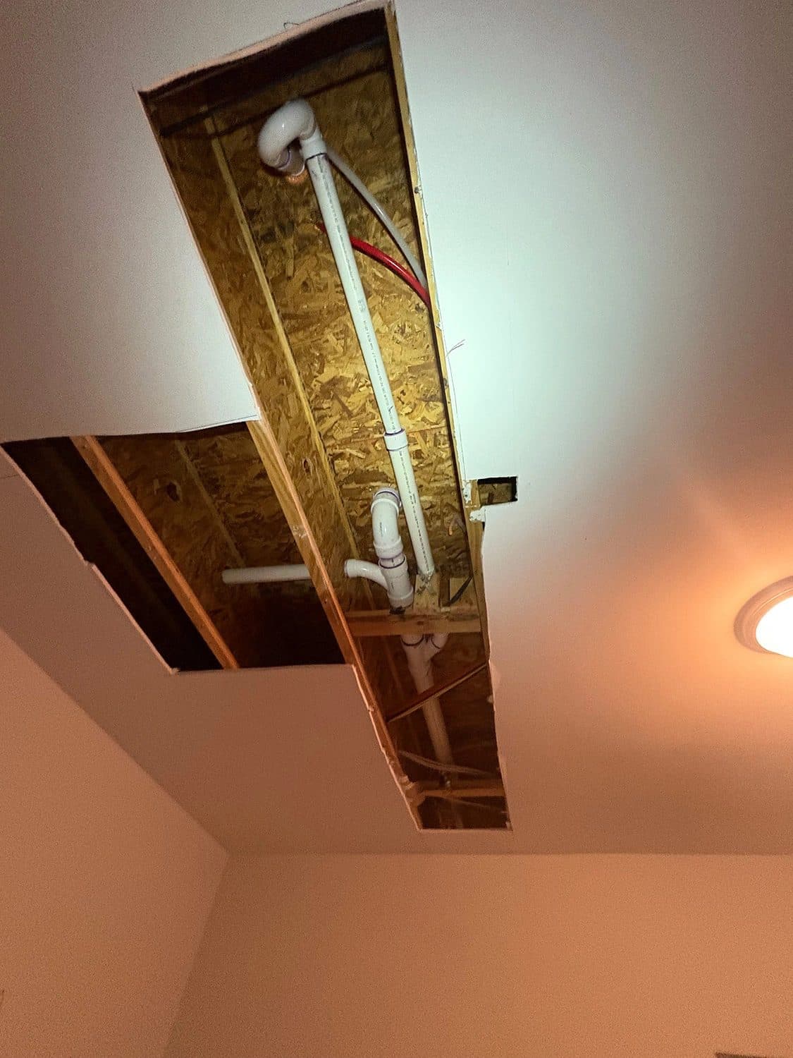 Ceiling access cut for a repipe in a bedroom