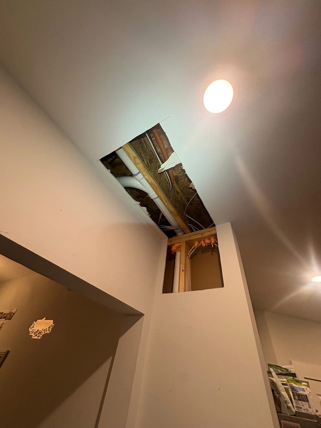 Hallway ceiling opened for access during a residential repipe